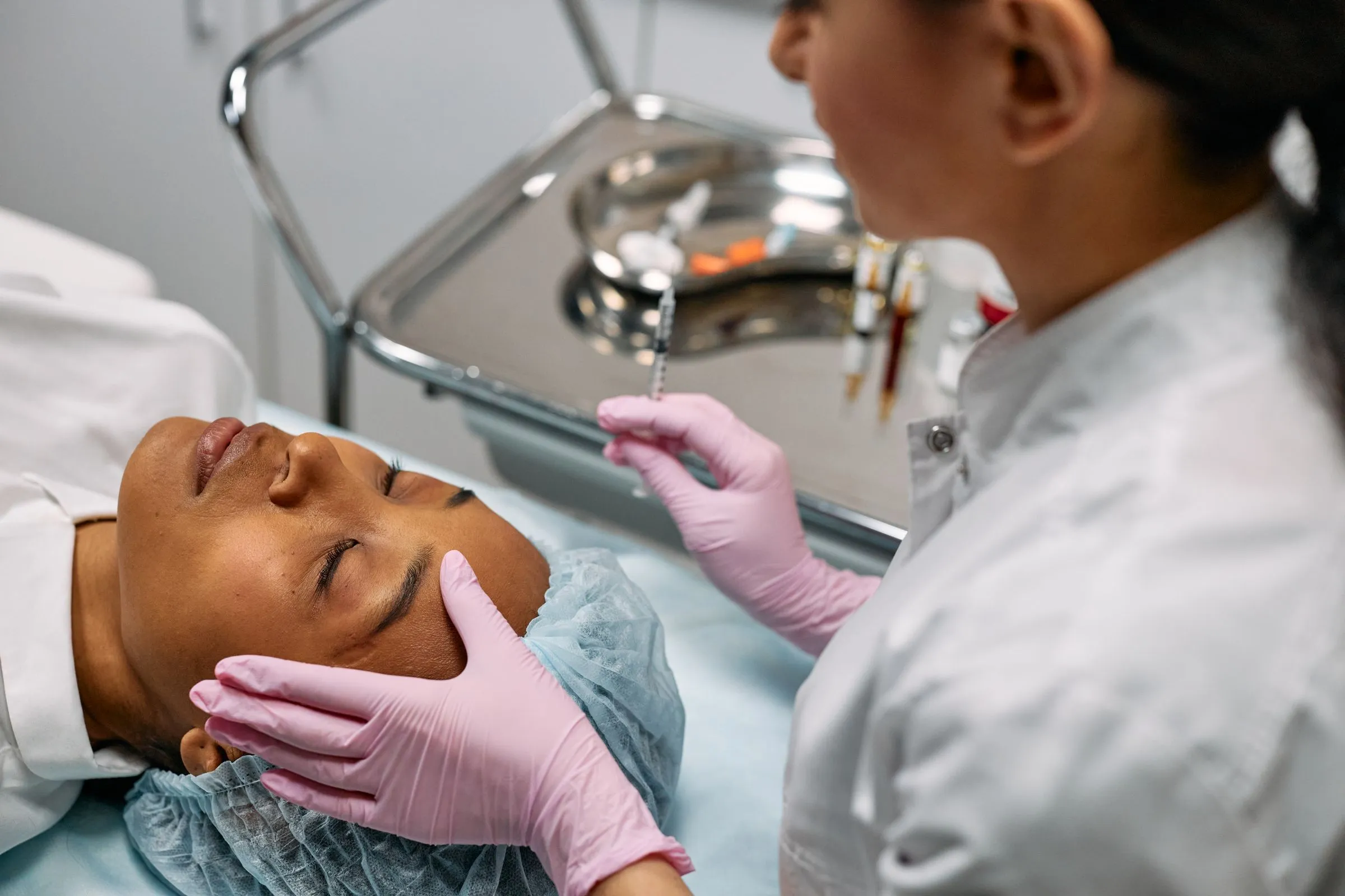 Aesthetician preparing a client for a clinical treatment