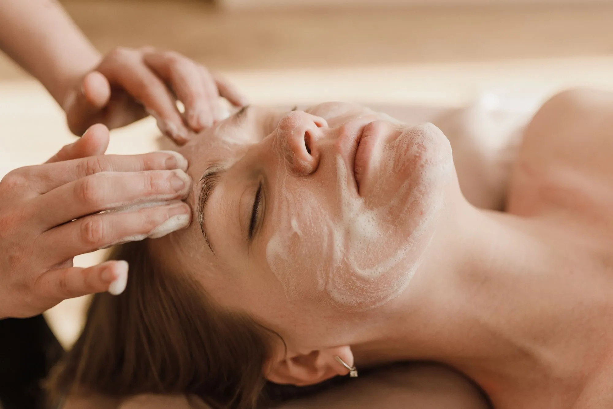 Client relaxing during a facial massage