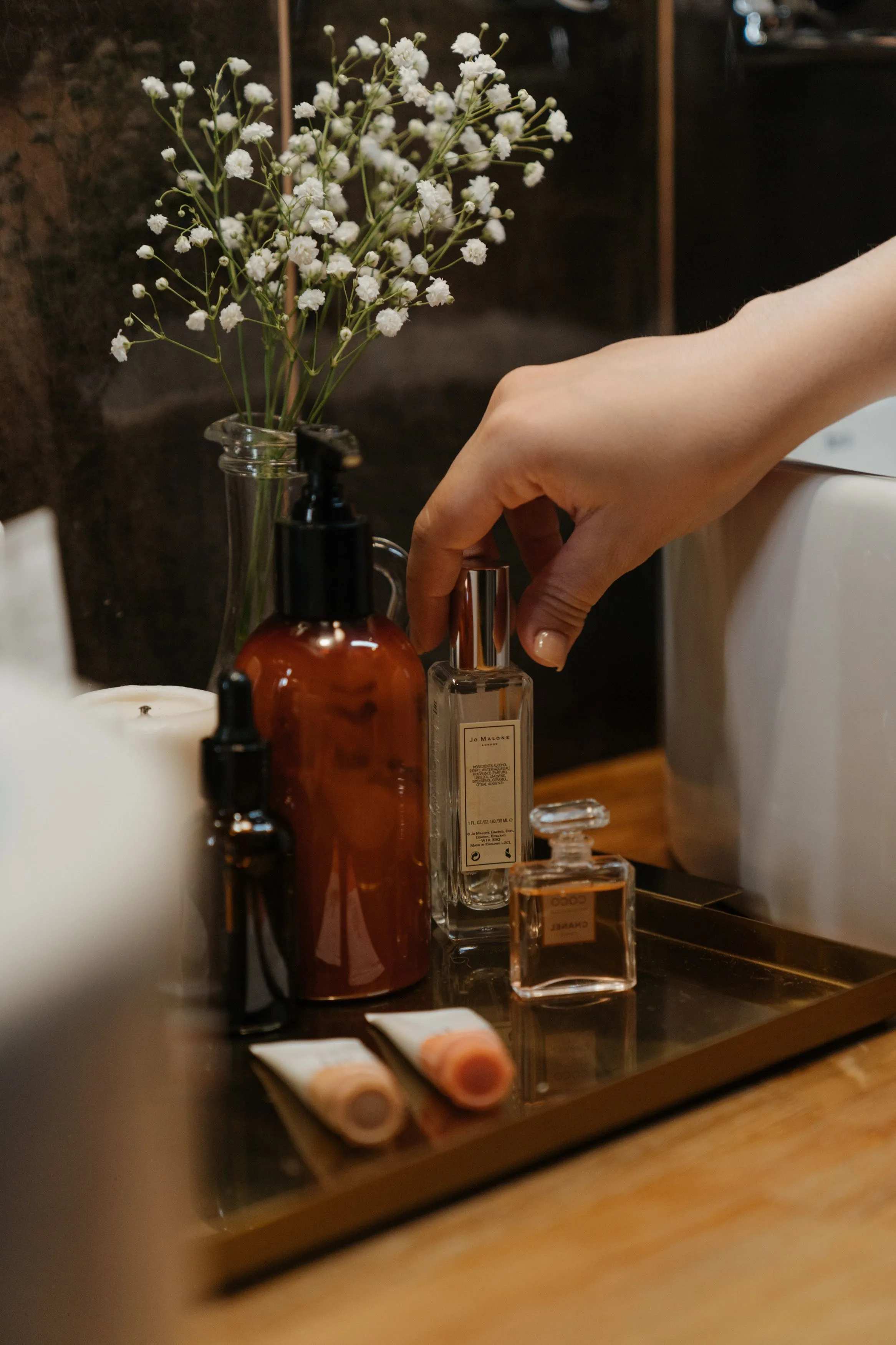 Amber skin care bottles with fresh flowers
